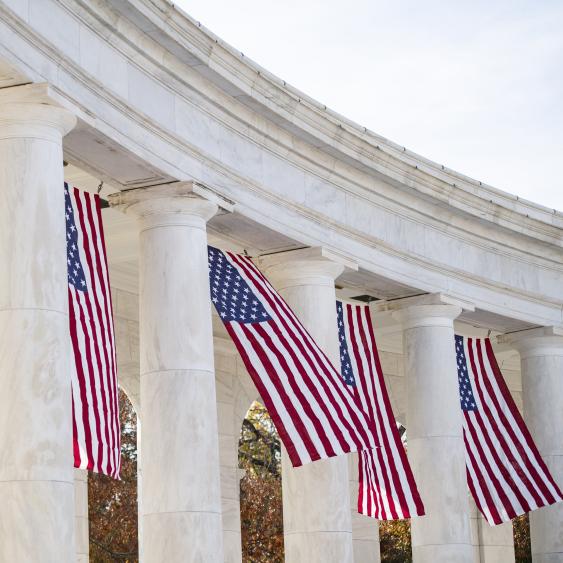 Flags hanging next to pillars