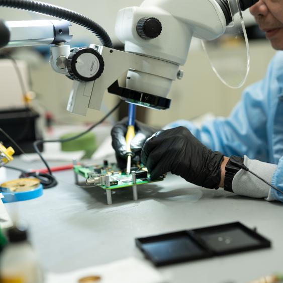 Worker examining tech part