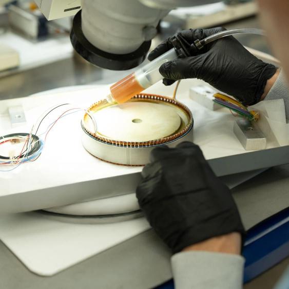 Close up of employee working on parts